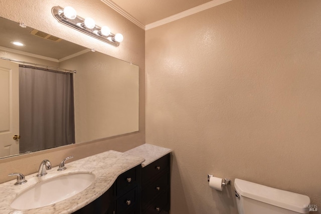 bathroom featuring crown molding, vanity, and toilet