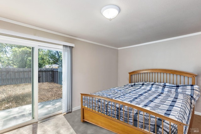 carpeted bedroom featuring ornamental molding and access to exterior