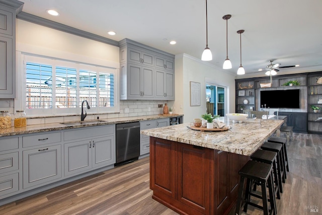 kitchen featuring ceiling fan, hanging light fixtures, tasteful backsplash, dishwasher, and gray cabinets