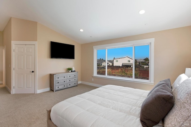 carpeted bedroom with vaulted ceiling