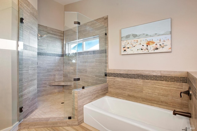 bathroom featuring wood-type flooring and plus walk in shower