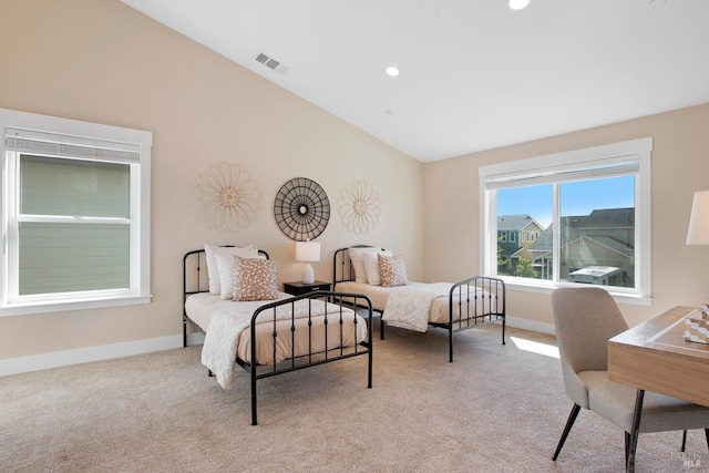 bedroom with light colored carpet and vaulted ceiling