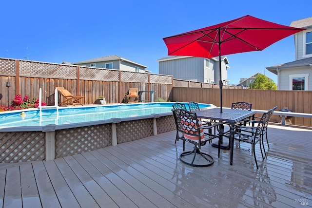 deck with a fenced in pool