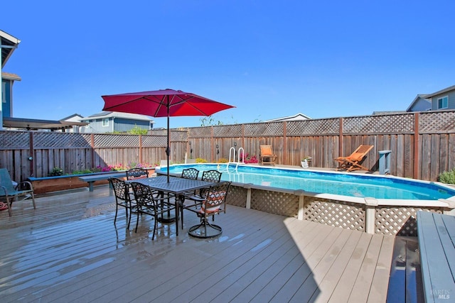 wooden deck with a fenced in pool