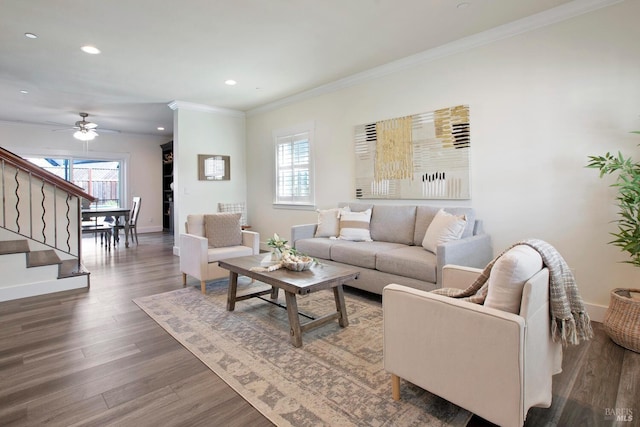 living room with ceiling fan, dark hardwood / wood-style floors, ornamental molding, and a wealth of natural light