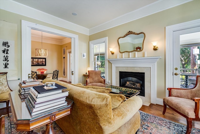 living room featuring ornamental molding and wood-type flooring