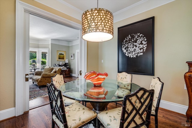 dining room featuring crown molding and dark hardwood / wood-style floors