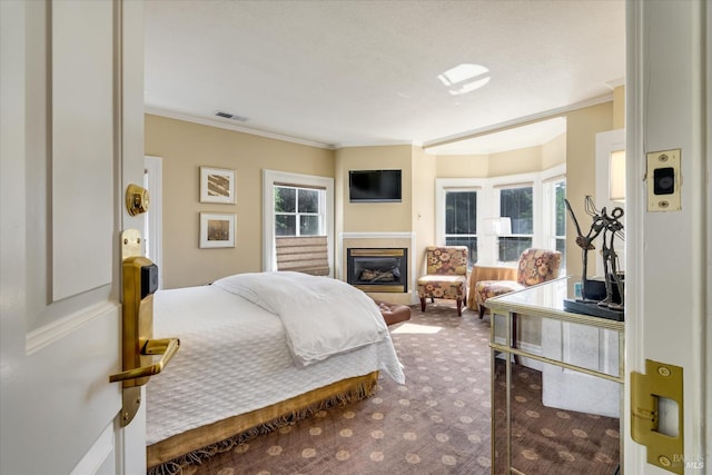 bedroom featuring ornamental molding, carpet, and multiple windows