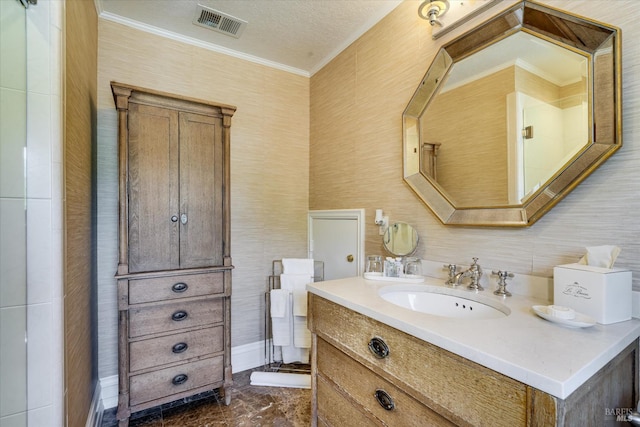 bathroom with vanity, crown molding, and a textured ceiling