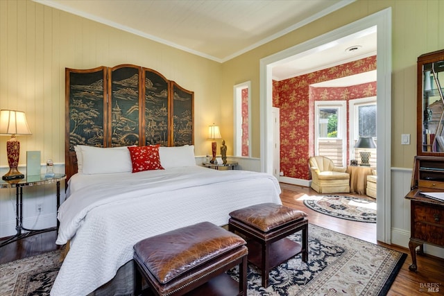 bedroom featuring ornamental molding, wood walls, and hardwood / wood-style floors