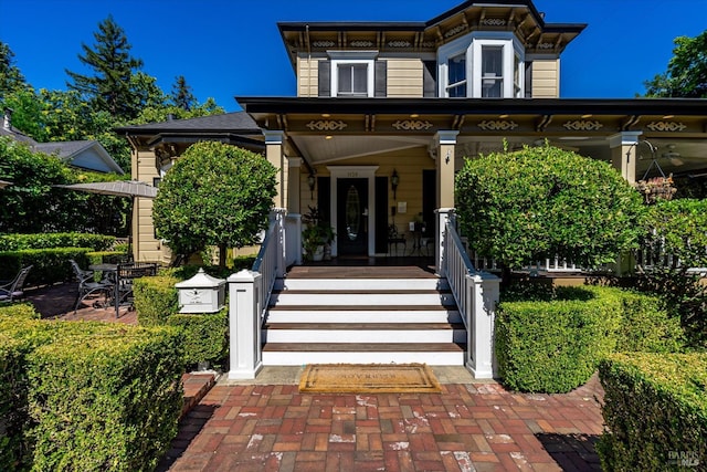 italianate house featuring covered porch