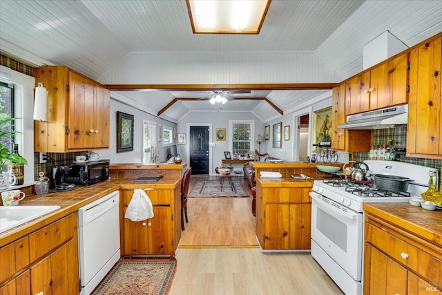 kitchen featuring ceiling fan, lofted ceiling, tasteful backsplash, white appliances, and light hardwood / wood-style flooring