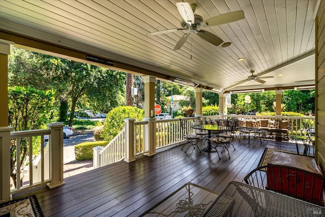 wooden deck featuring ceiling fan