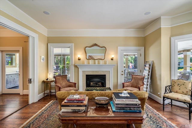 living room featuring ornamental molding, dark wood-type flooring, and plenty of natural light