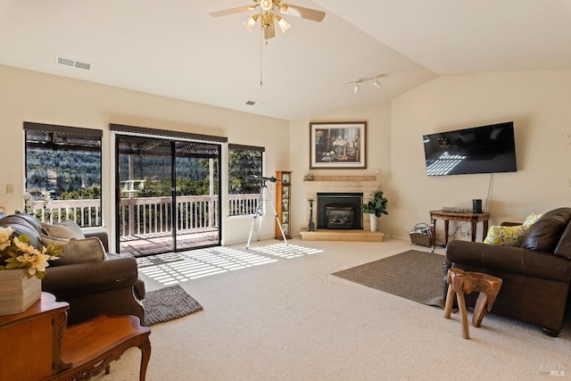 carpeted living room with vaulted ceiling and ceiling fan