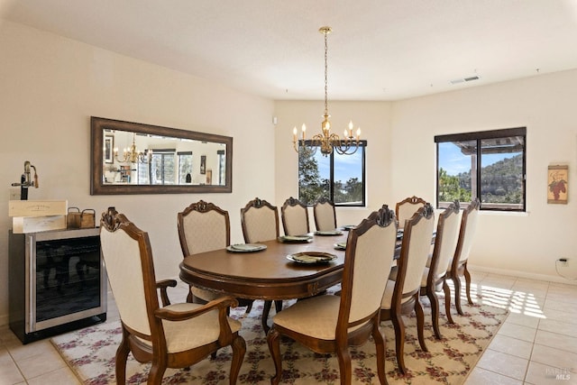 dining area featuring light tile patterned floors and a notable chandelier