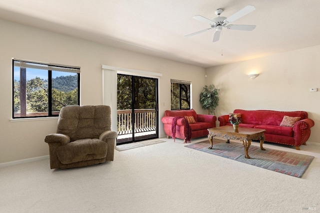 living room with ceiling fan and carpet floors