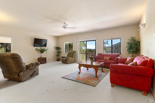 carpeted living room featuring ceiling fan