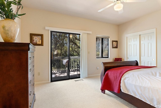 carpeted bedroom with ceiling fan, a closet, and access to exterior