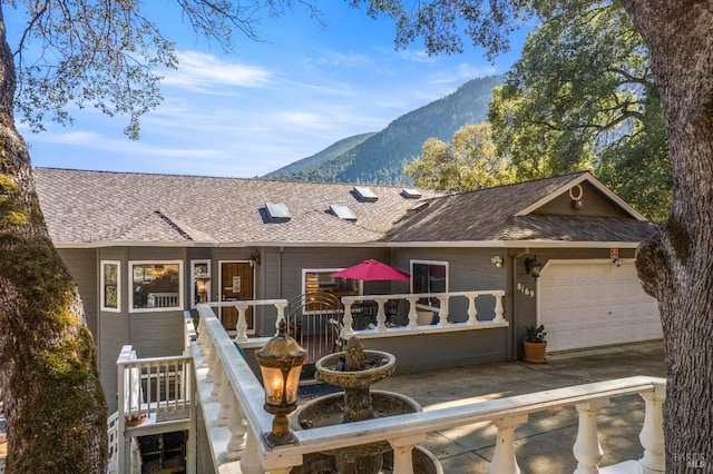 view of front facade with a garage and a mountain view