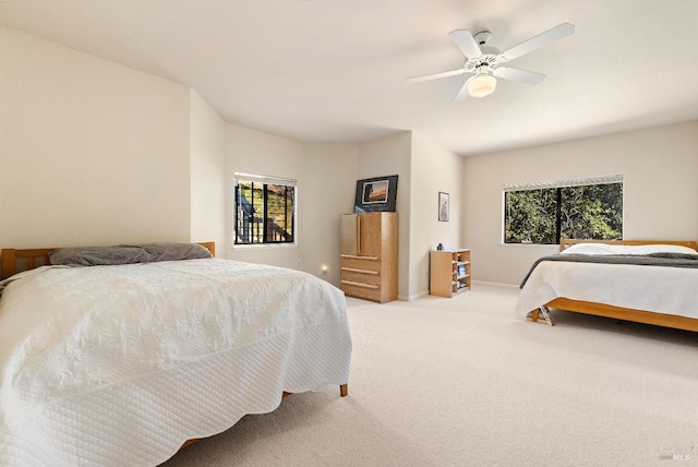 bedroom featuring ceiling fan and light colored carpet