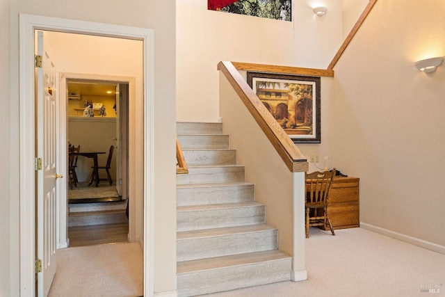 staircase featuring carpet flooring