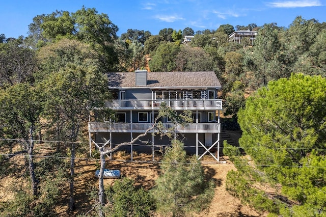 back of property with a balcony