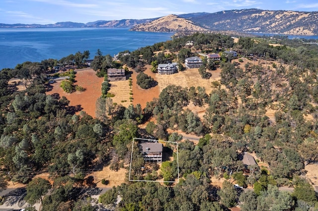 birds eye view of property with a water and mountain view