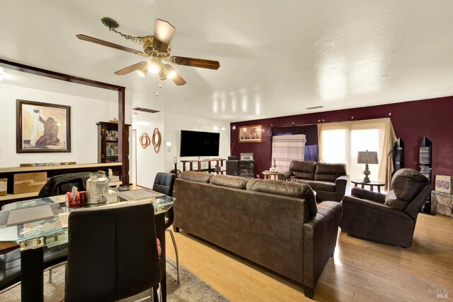 living room with ceiling fan and light wood-type flooring