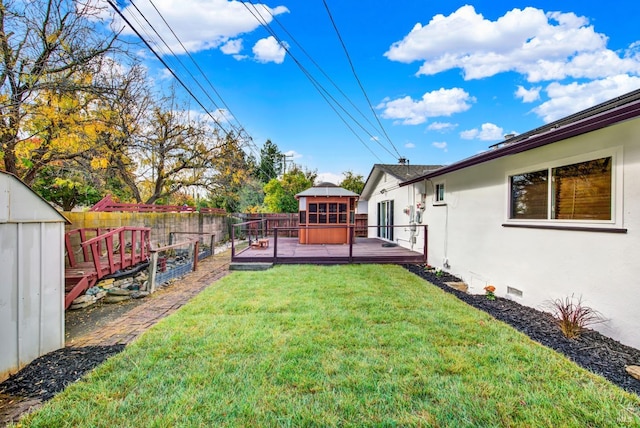 view of yard featuring a shed and a deck