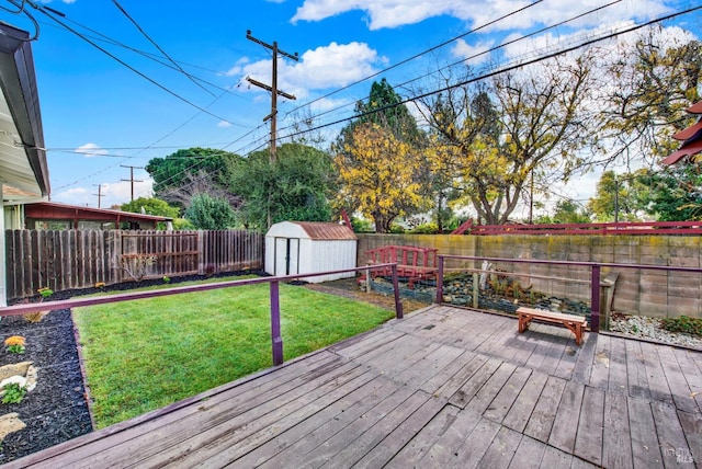 wooden terrace with a lawn and a storage unit