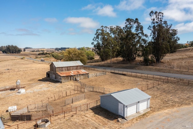 view of yard featuring an outdoor structure and a rural view