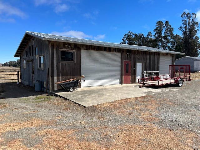 view of front of house featuring an outdoor structure and a garage