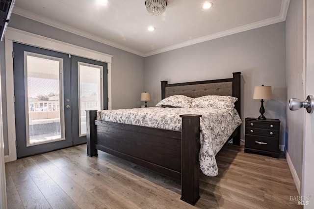 bedroom with wood-type flooring, access to exterior, and crown molding