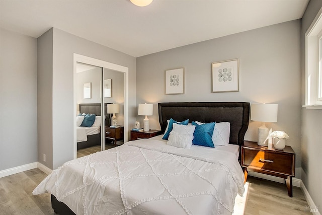 bedroom with hardwood / wood-style flooring and a closet