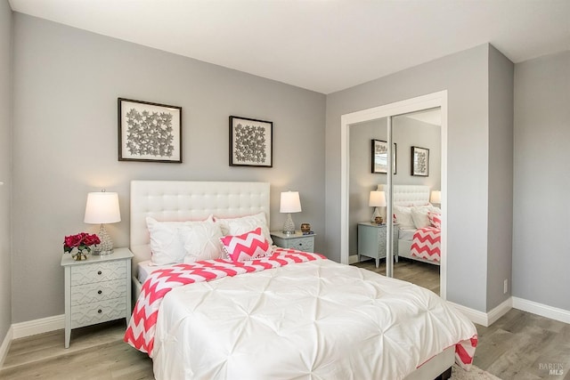 bedroom featuring hardwood / wood-style floors and a closet