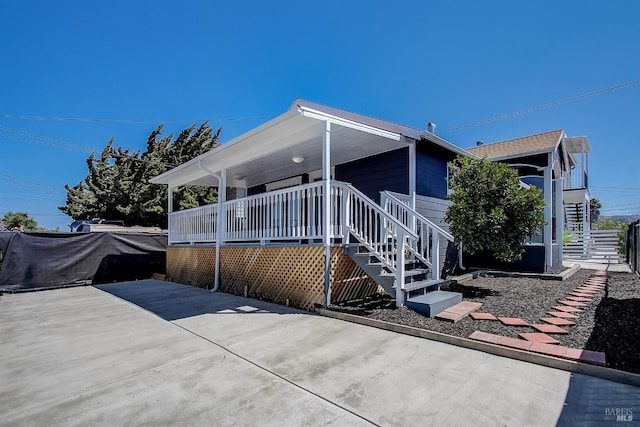 back of property with covered porch