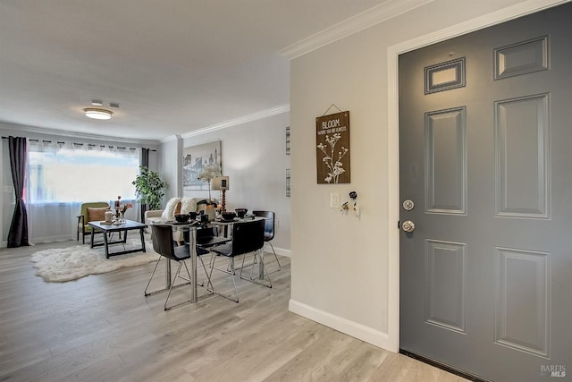 foyer entrance featuring light hardwood / wood-style floors and crown molding