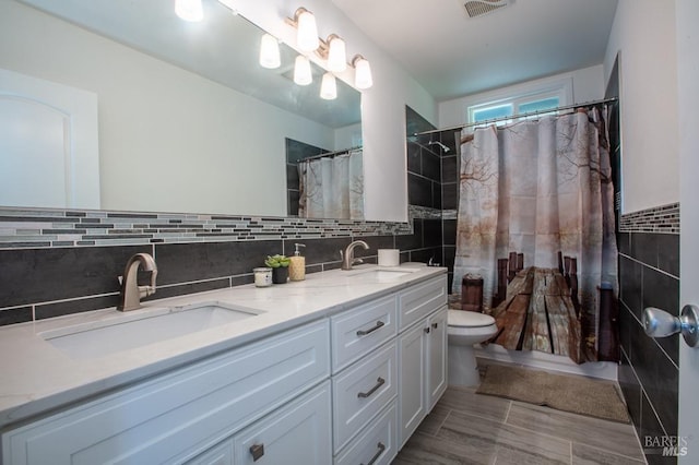 bathroom featuring vanity, tile walls, toilet, and a shower with shower curtain