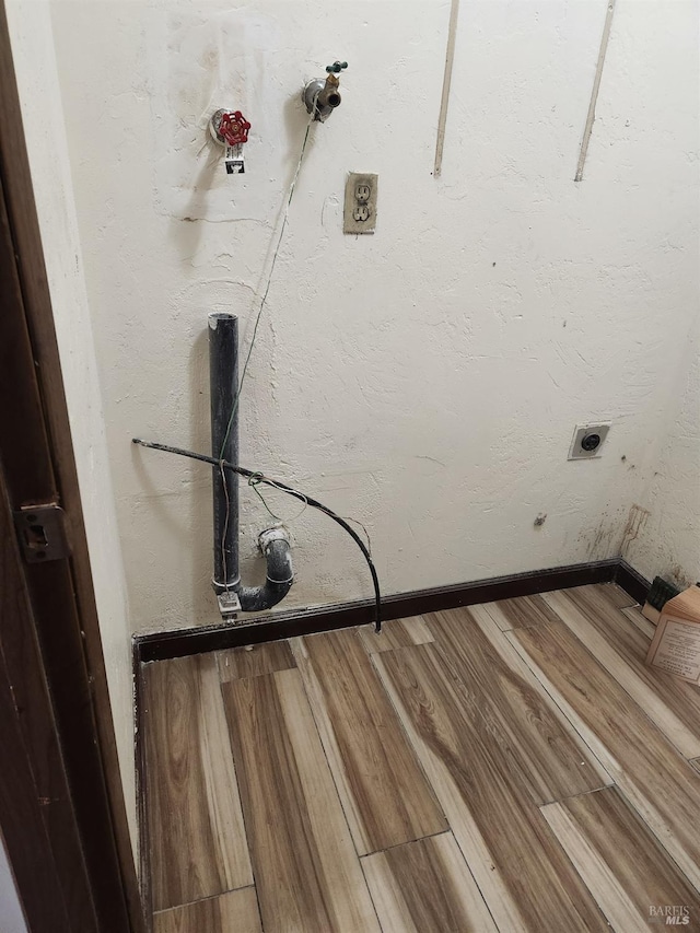 341 Inverness Dr, Vallejo, CA 94589 - laundry area with wood finished floors, a textured wall, baseboards, and electric dryer hookup