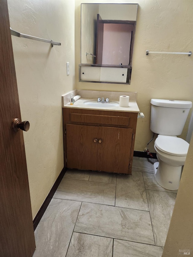 341 Inverness Dr, Vallejo, CA 94589 - bathroom with a textured wall, vanity, baseboards, and toilet