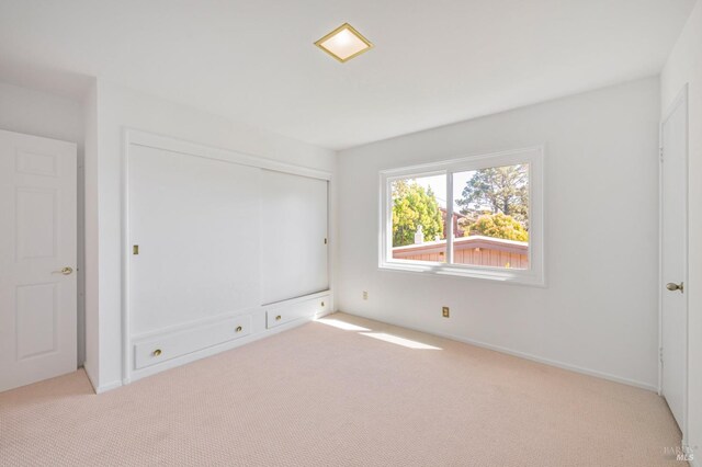 unfurnished bedroom with carpet and a closet