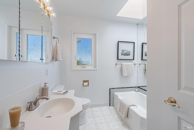 full bathroom with a bath, baseboards, toilet, tile patterned floors, and vanity