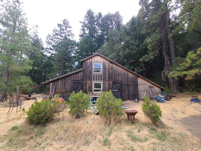 view of property exterior featuring an outbuilding