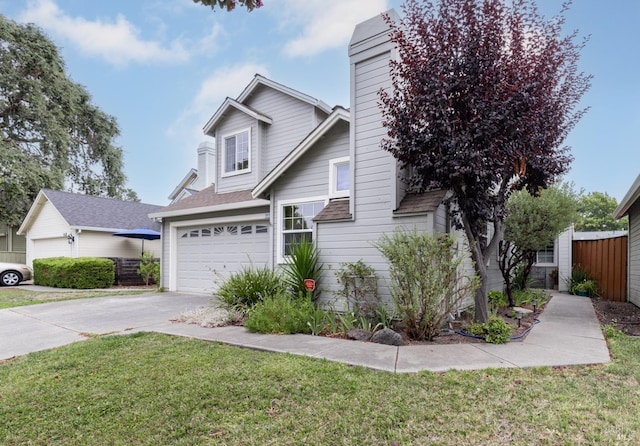 view of front of property featuring a garage and a front yard