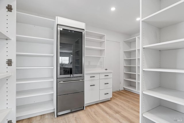 walk in closet featuring light hardwood / wood-style flooring