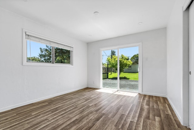 unfurnished room with dark hardwood / wood-style floors