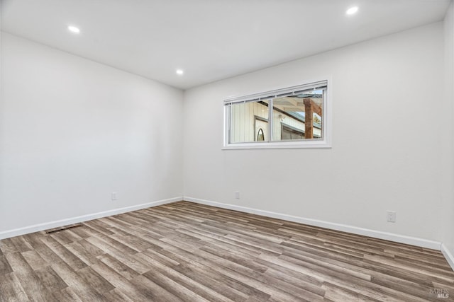 spare room with hardwood / wood-style flooring