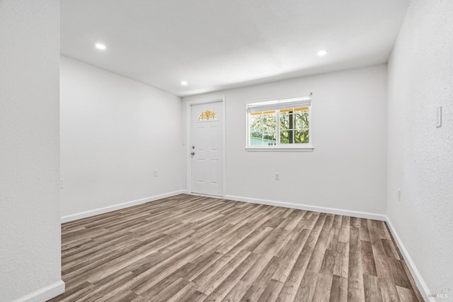 empty room with hardwood / wood-style floors