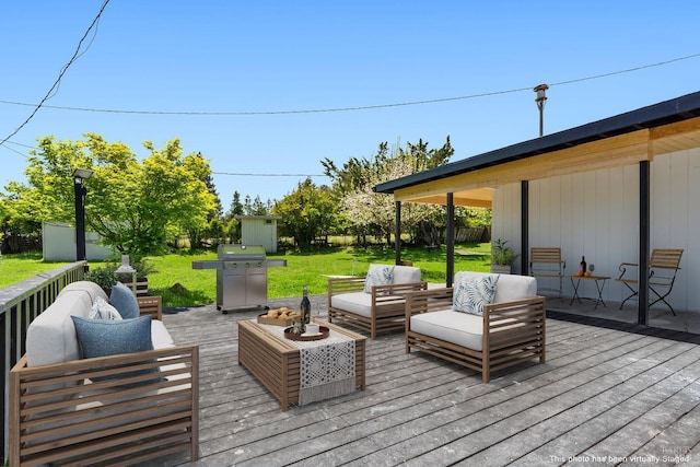 wooden deck featuring grilling area, an outdoor living space, a storage shed, and a yard